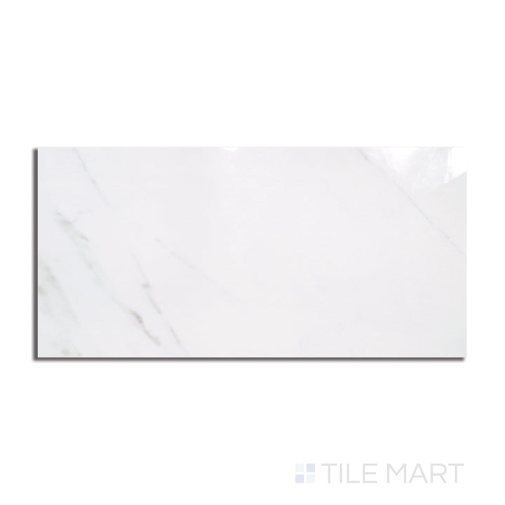 Top-down view of Marmolab Calacatta 24x48 glossy porcelain tile, showing bold veining across a white marble-look surface with a polished sheen.