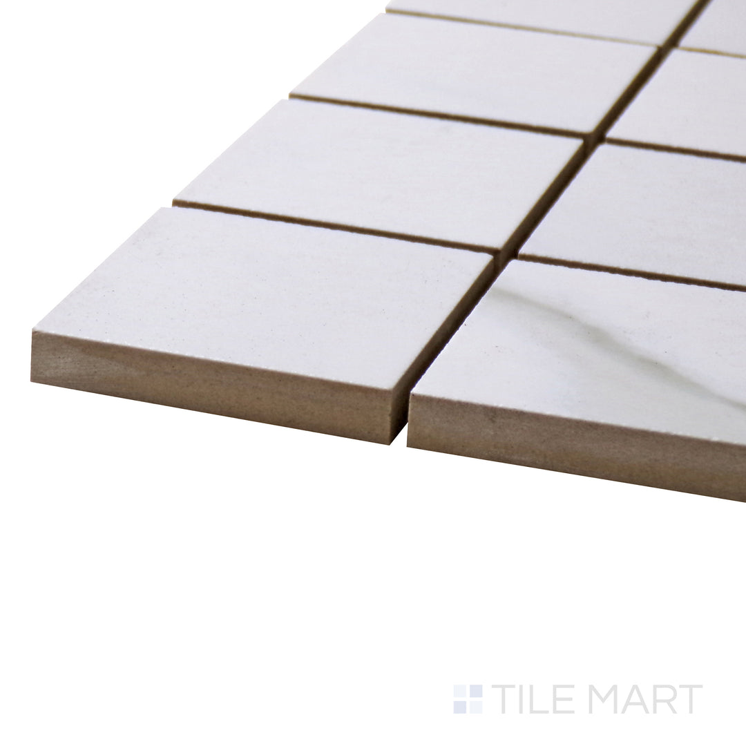 Calacatta mosaic squares shimmer at the edge, showing off Marmolab’s elegant 2" Glossy Porcelain.