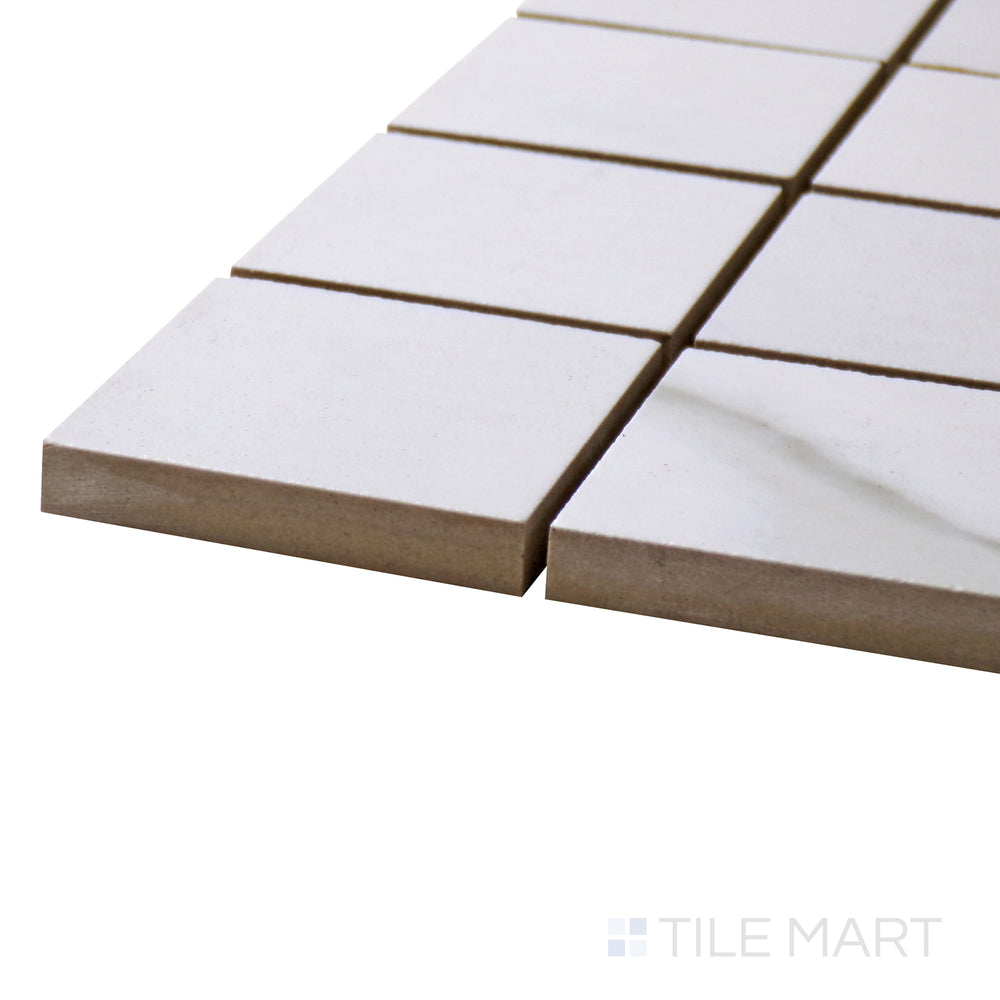 Calacatta mosaic squares shimmer at the edge, showing off Marmolab’s elegant 2" Glossy Porcelain.