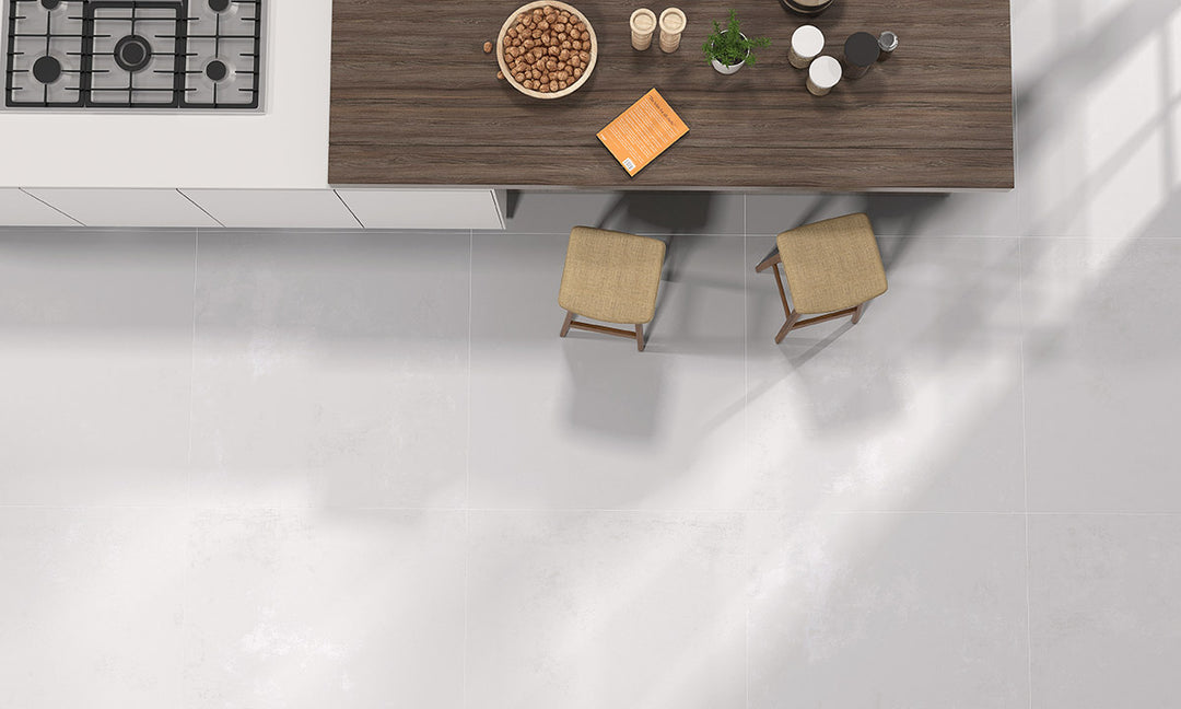 A luminous and elegant lifestyle space featuring Kadence Blanco polished porcelain, enhancing the atmosphere with its radiant surface.