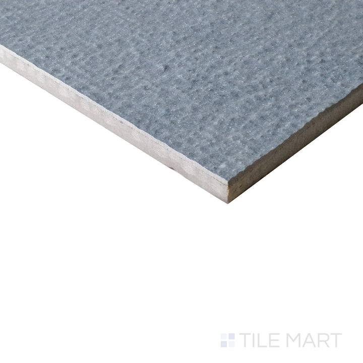 Angled shot of Urban Living Coastal 12x24 chiseled porcelain tile, featuring its textured edges, neutral tones, and rustic stone-like appearance.  