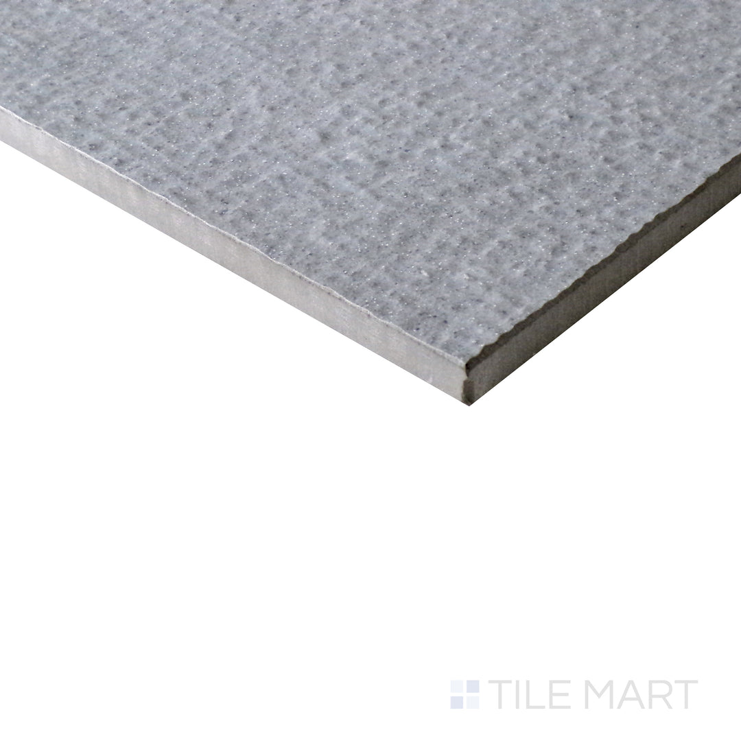 Slanted perspective of Urban Living Mist Grey 12x24 chiseled porcelain tile, highlighting its misty gray hues, unique chiseled edges, and contemporary matte texture.  