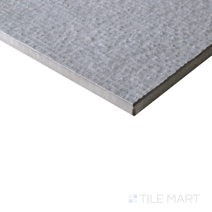 Slanted perspective of Urban Living Mist Grey 12x24 chiseled porcelain tile, highlighting its misty gray hues, unique chiseled edges, and contemporary matte texture.  