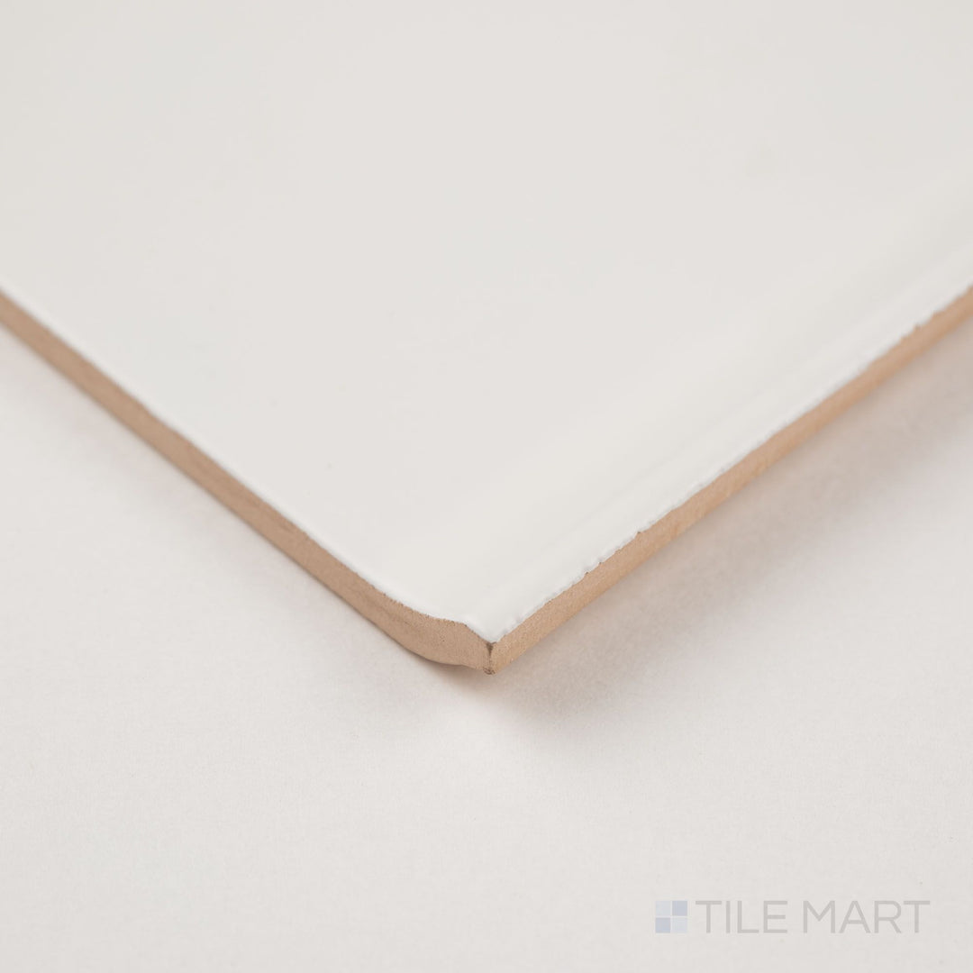 Corner detail of white sanitary cove base 6x6 matte ceramic tile showing curved base profile