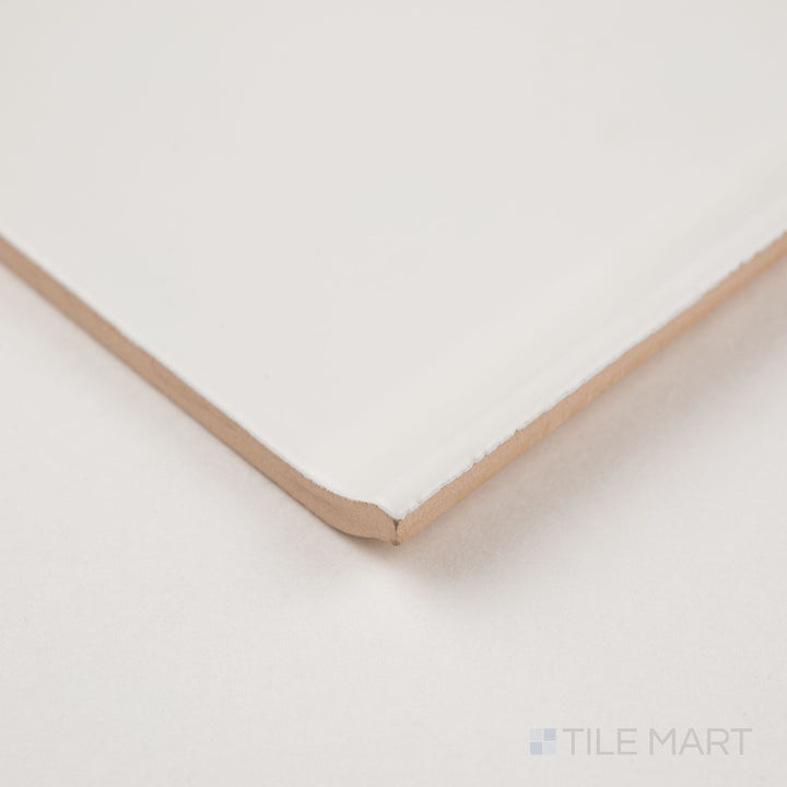 Corner detail of white sanitary cove base 6x6 matte ceramic tile showing curved base profile