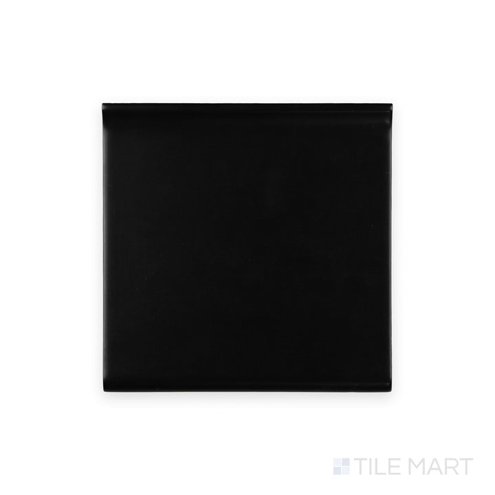 Full-piece detail of black sanitary cove base 6x6 matte ceramic tile with rounded base edge