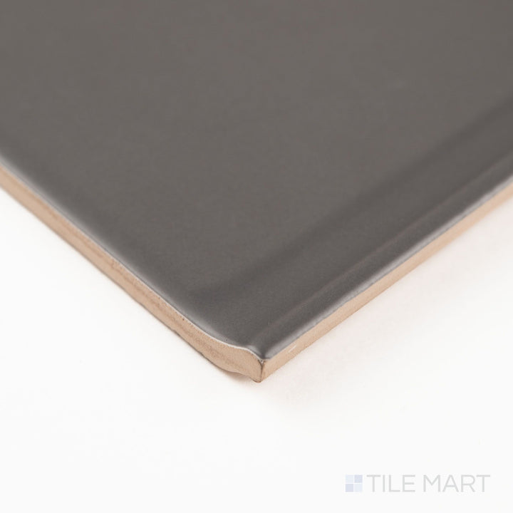Corner view of dark gray sanitary cove base 6x6 matte ceramic tile highlighting smooth curved base profile