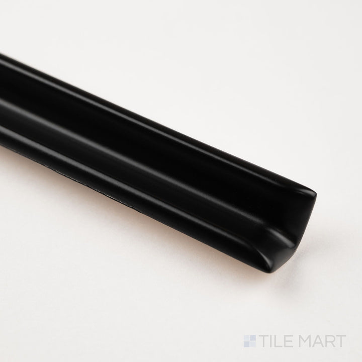 Corner detail of black sanitary cove base 1x6 inside corner matte ceramic trim revealing clean interior profile
