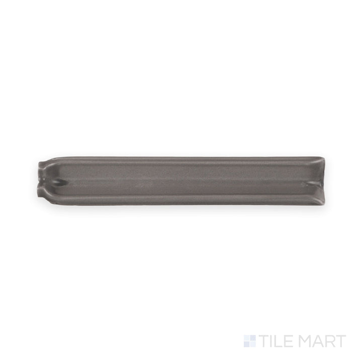 Top-down detail of dark gray sanitary cove base 1x6 inside corner matte ceramic trim