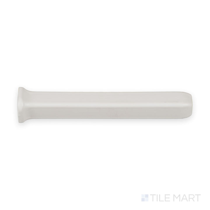 Full-piece view of white sanitary cove base 1x6 outside corner matte ceramic trim with molded exterior angle