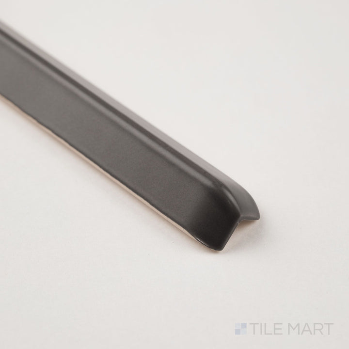 Dark gray sanitary cove base 1x6 outside corner trim shown at corner angle with molded exterior profile