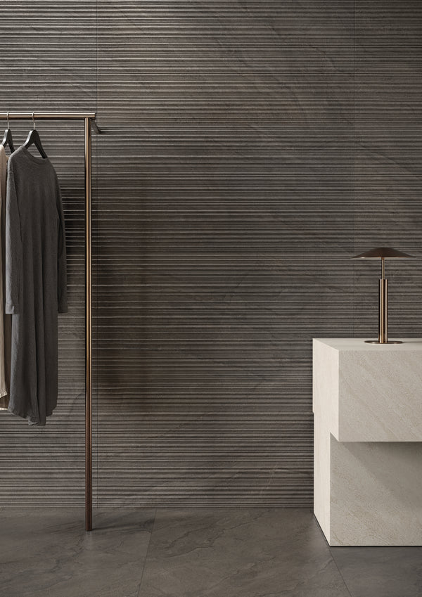 Pietra Di Orosei Grigio Bruciato 3D Deco brings an understated, softly textured character to a matte tile design.
