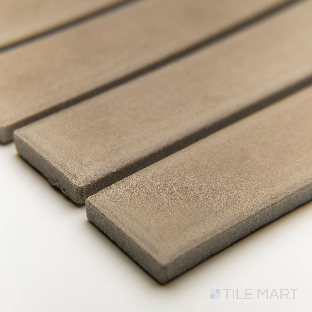 Corner angle showcasing Amuri Grigio 1x6 matte mosaic tiles with a subtle linear layout and fine porcelain texture.