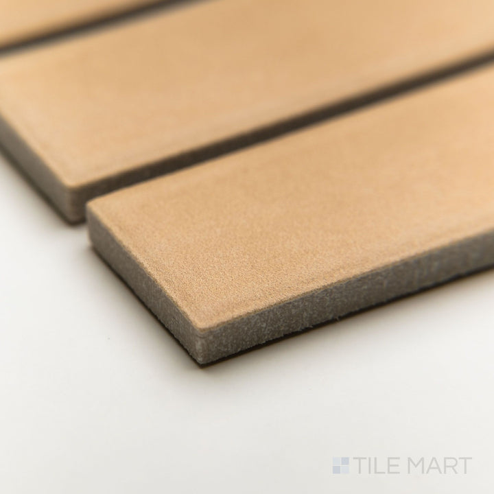 Corner view of Amuri Biscotto 1x6 grid mosaic tiles in warm earthy tones, displaying its precise matte finish and slim linear form.
