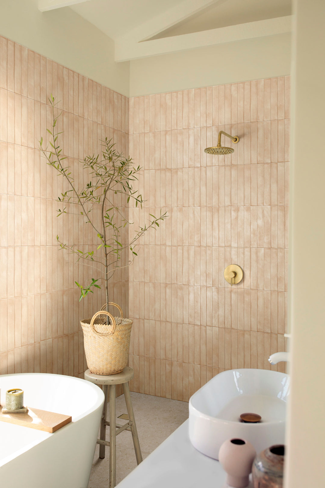 Bathroom with beige tiled walls, a bathtub, and decorative elements, styled with Amuri Brick Biscotto 2x12 Matte Porcelain Tile for a warm, earthy ambiance.