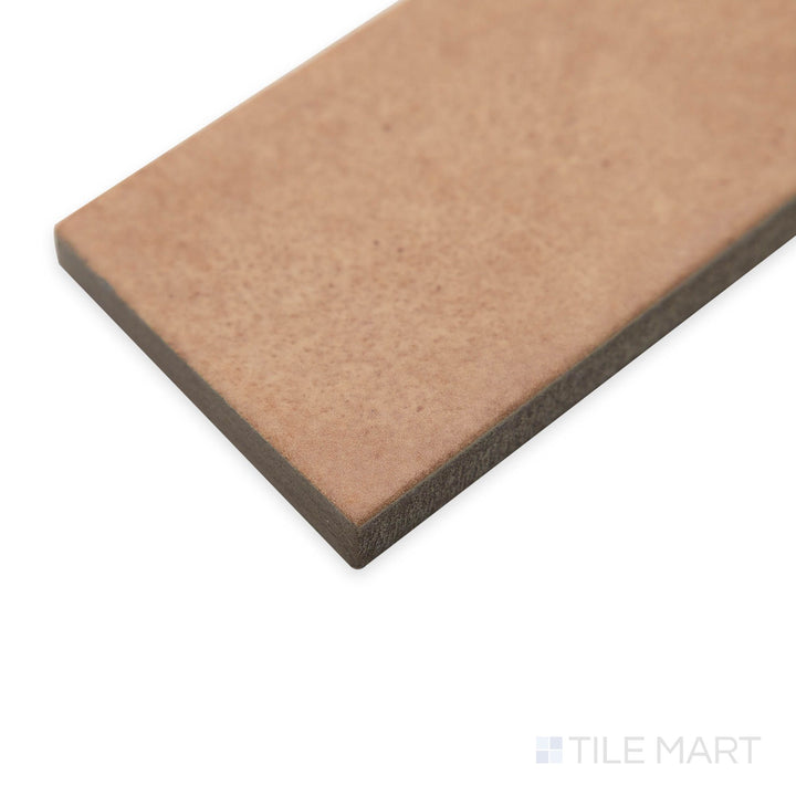 Corner perspective of Amuri Brick Cotto 2x12 matte tiles, emphasizing its rich, earthy tone and linear brick format.