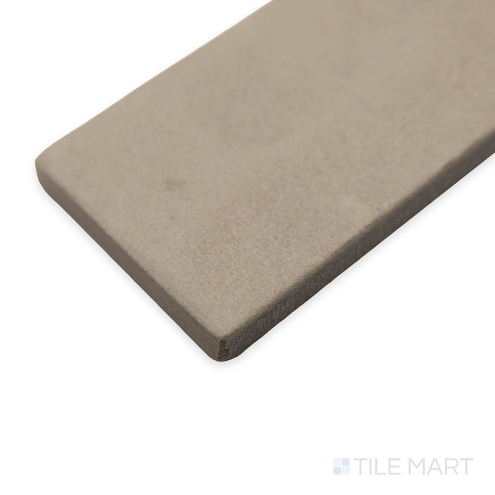Side view showcasing Amuri Brick Grigio 2x12 porcelain tile, capturing its cool gray tones and refined matte surface.