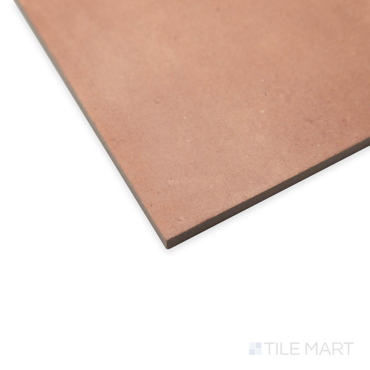 Angled capture of Amuri Cotto 8x8 tile with rustic reddish hues, emphasizing its handcrafted appeal and matte texture.