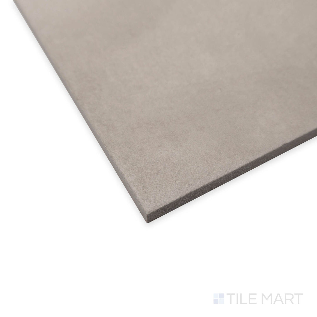 Perspective view of Amuri Grigio 8x8 porcelain tile in a neutral gray shade with soft surface reflections.
