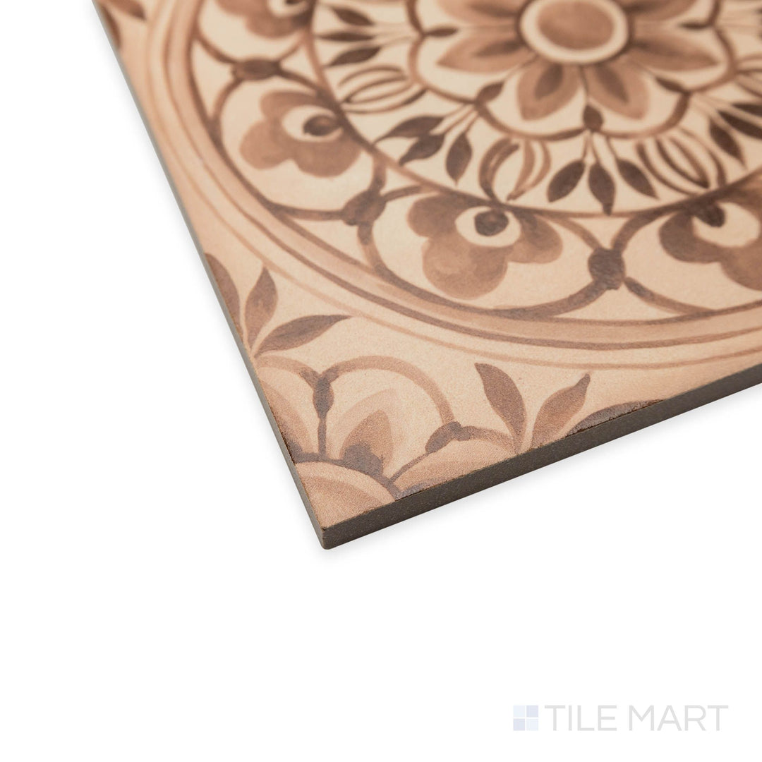 Angled display of Amuri Decoro Pizzo Biscotto tile featuring intricate decorative motifs and warm tan coloring.
