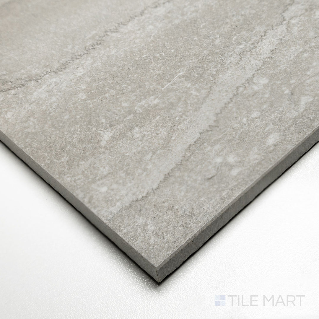 Corner shot of Dorset Vein Cut Cenere 24x48 tile emphasizing bold gray veining across an elongated matte surface.