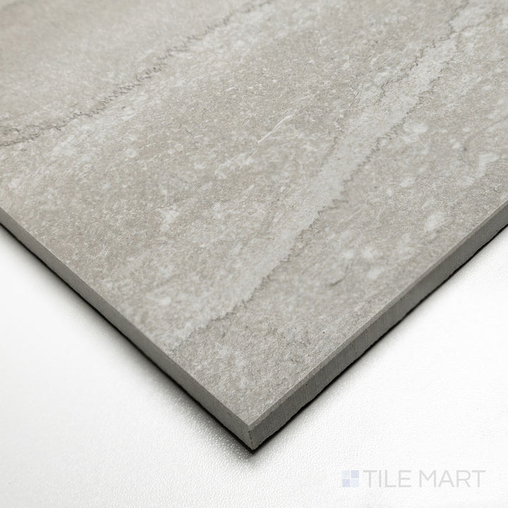 Corner shot of Dorset Vein Cut Cenere 24x48 tile emphasizing bold gray veining across an elongated matte surface.