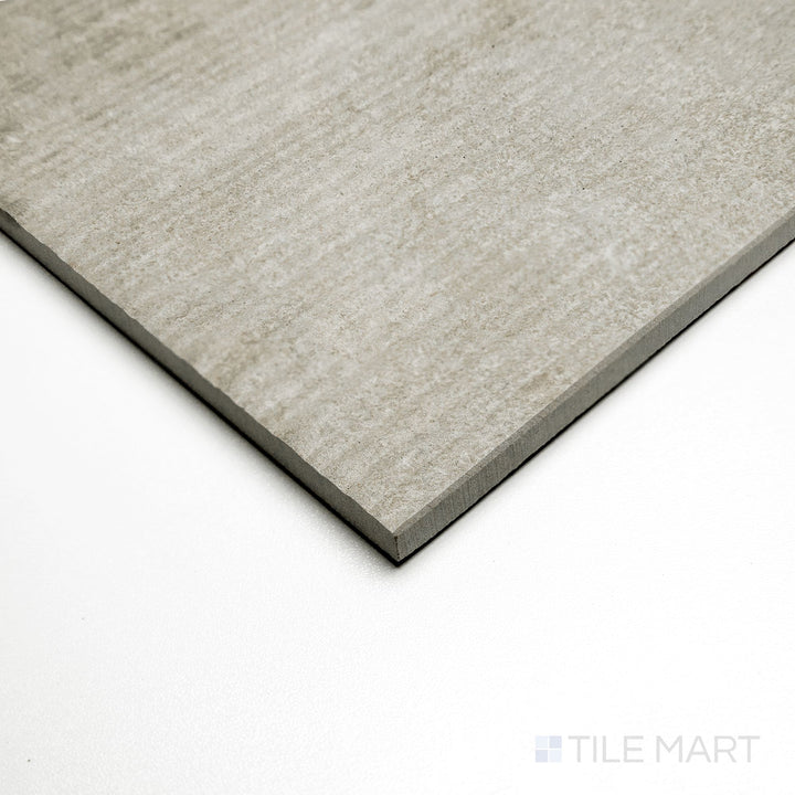 Angled view of Dorset Ribbed Tortora 24x48 tile displaying soft taupe lines with a ribbed surface detail.