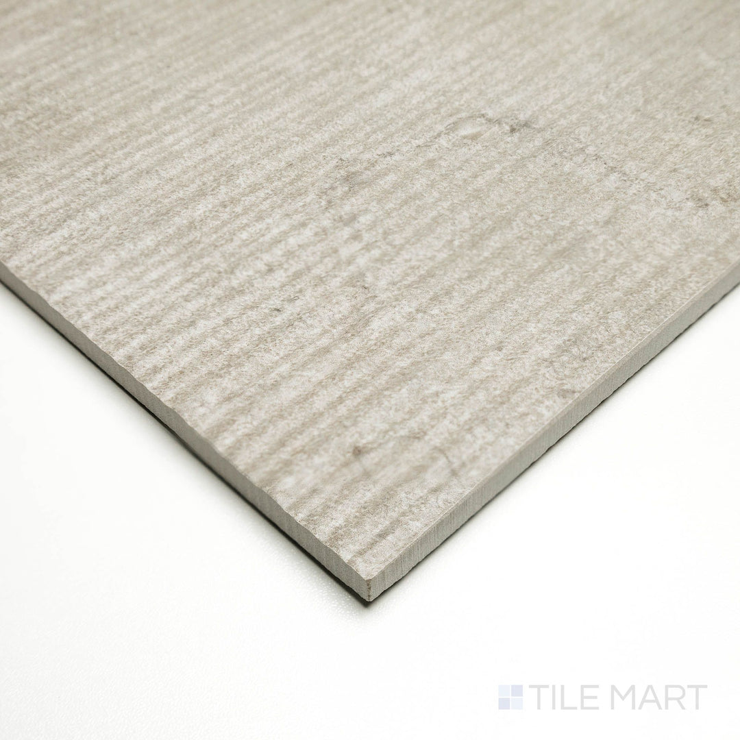 Corner shot of Dorset Ribbed Cenere 24x48 tile featuring vertical ridges and cool gray coloring for a modern aesthetic.