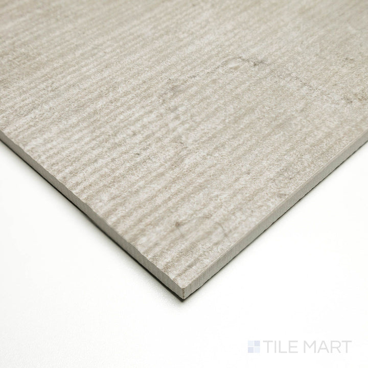 Corner shot of Dorset Ribbed Cenere 24x48 tile featuring vertical ridges and cool gray coloring for a modern aesthetic.