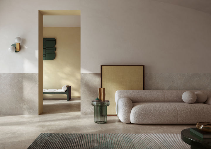 Modern living room with a beige sofa, coffee table, and decor, designed with Dorset Cross Cut Tortora 24x24 Matte Porcelain Tile for natural texture and warmth.