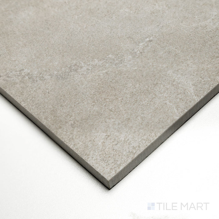 Angled capture of Dorset Cross Cut Cenere 24x24 tile highlighting cool gray hues and defined cross-cut stone texture.