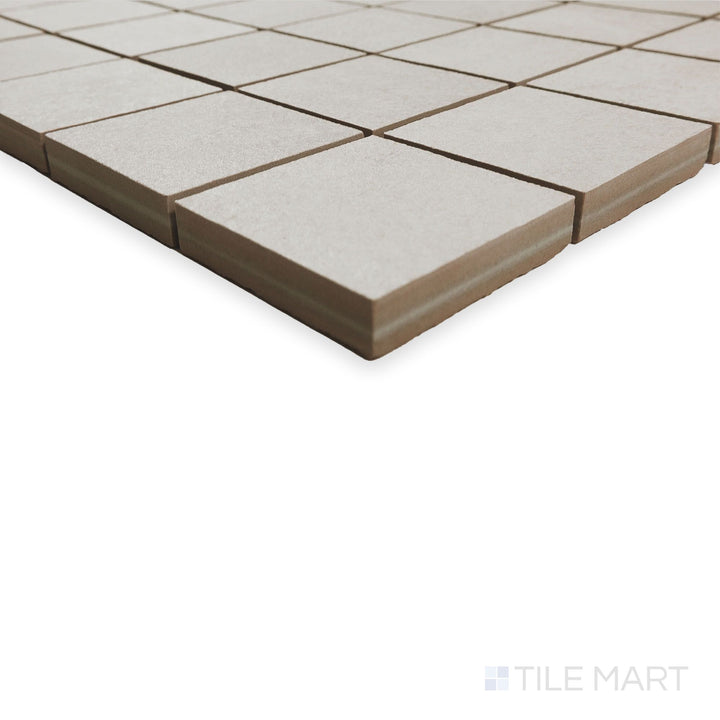 Edge-focused mosaic view of Hurricane White 2" square tiles arranged in a crisp grid pattern with light tone contrast.