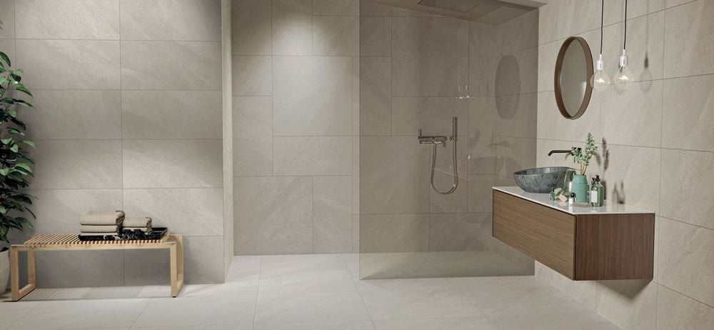 Modern bathroom featuring tiled walls, a sink, and a plant, complemented by Hurricane R11 Grip Sand 12x24 Texture Porcelain Tile for added texture and tone variation.