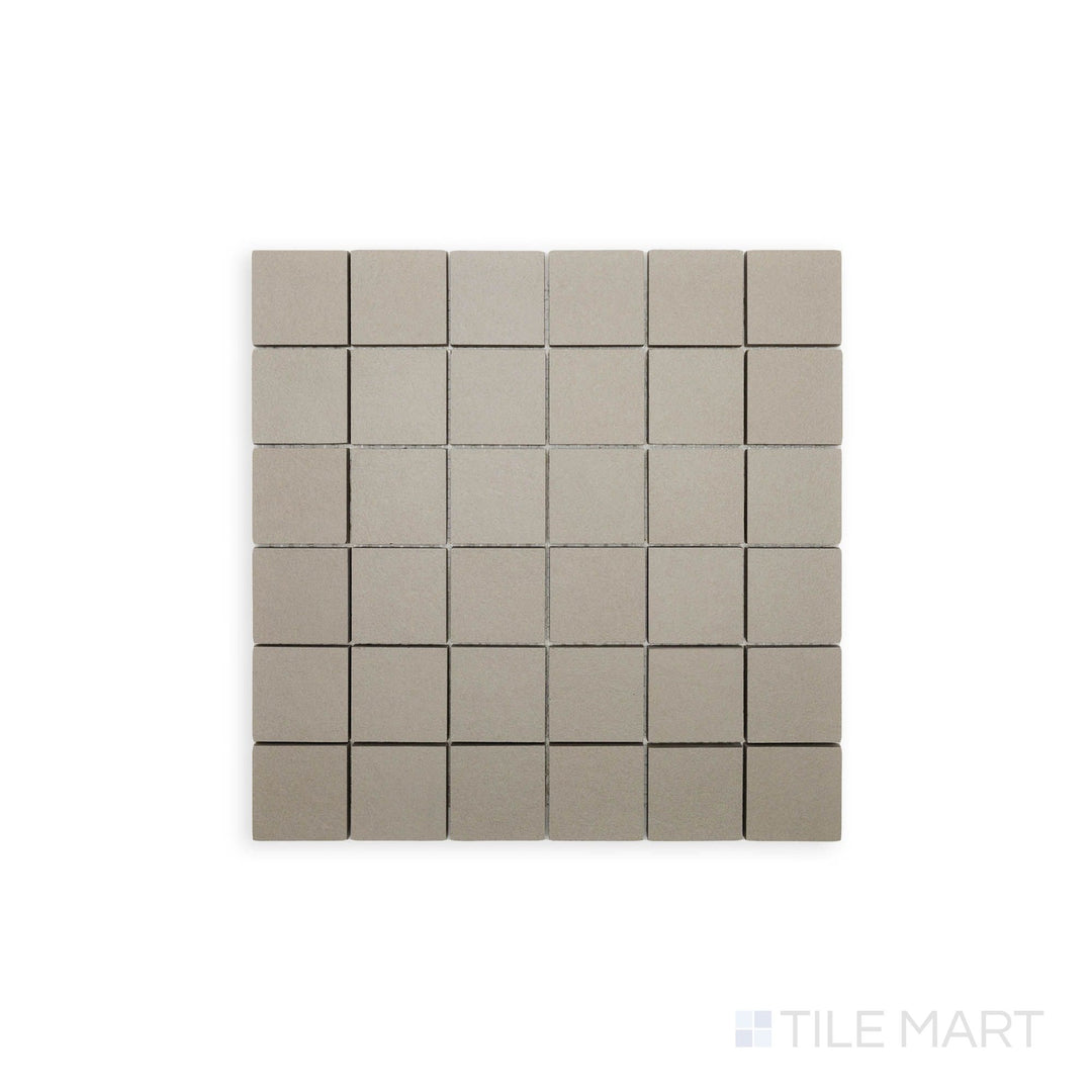 Flat-lay photograph of Nuances Tortora 2" Square Matte Porcelain Mosaic, showcasing warm taupe tones in a small-scale mosaic design for detailed surface applications.