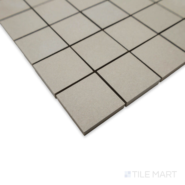 Angled detail of Nuances Tortora 2" square mosaic tiles emphasizing their balanced taupe shade and matte finish.