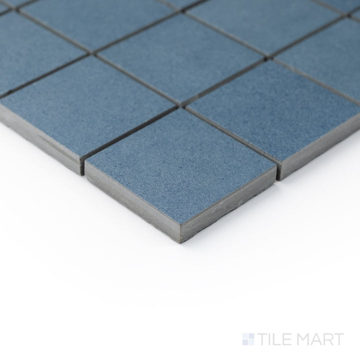 Oblique angle of Nuances Cielo 2" square mosaic tiles with a fresh blue color and precise grid pattern.