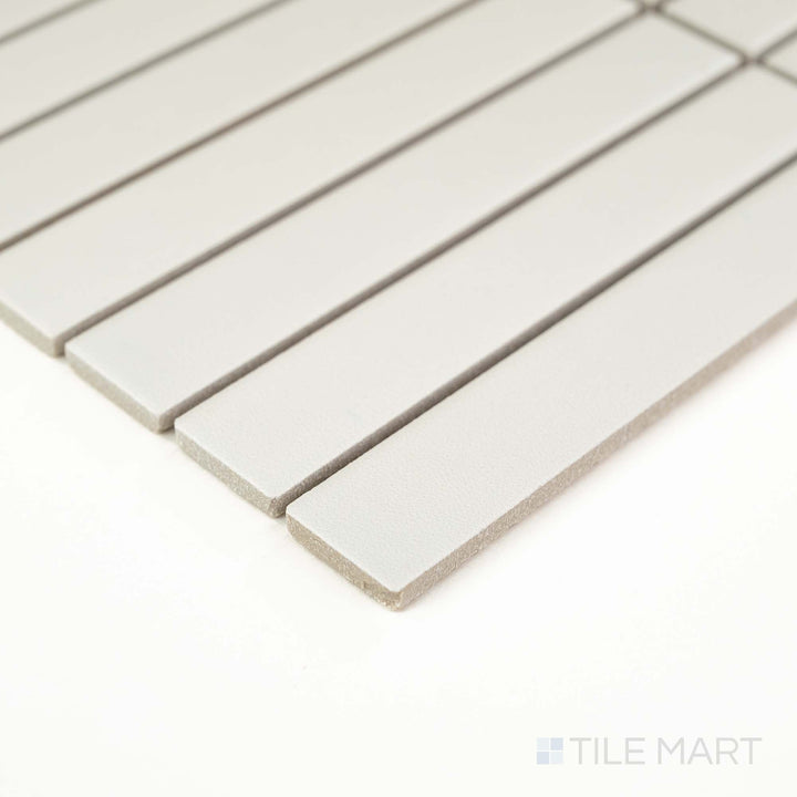 Corner view of Passaggi White 1x6 Grid Matte Porcelain Mosaic showcasing sleek white rectangular pieces arranged in a modern grid – perfect for backsplashes and shower walls.