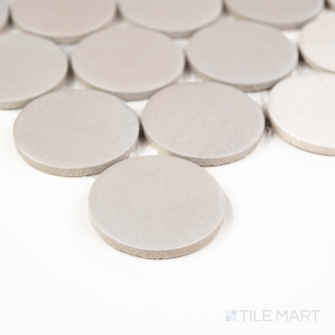 Corner shot of Passaggi Grey 2" Round Matte Porcelain Mosaic showcasing soft gray penny rounds with a matte texture – a versatile pick for vintage, modern, or spa-inspired settings.