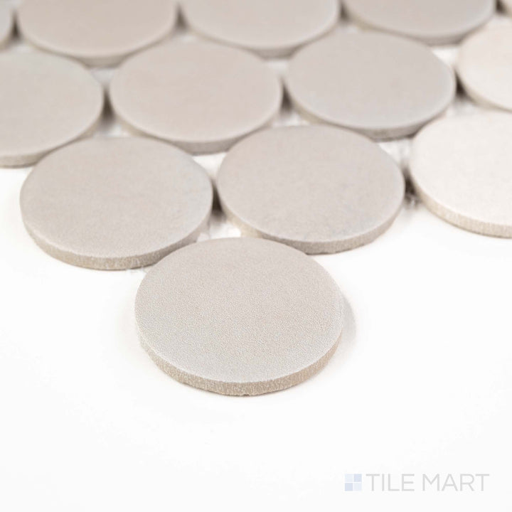 Corner shot of Passaggi Grey 2" Round Matte Porcelain Mosaic showcasing soft gray penny rounds with a matte texture – a versatile pick for vintage, modern, or spa-inspired settings.