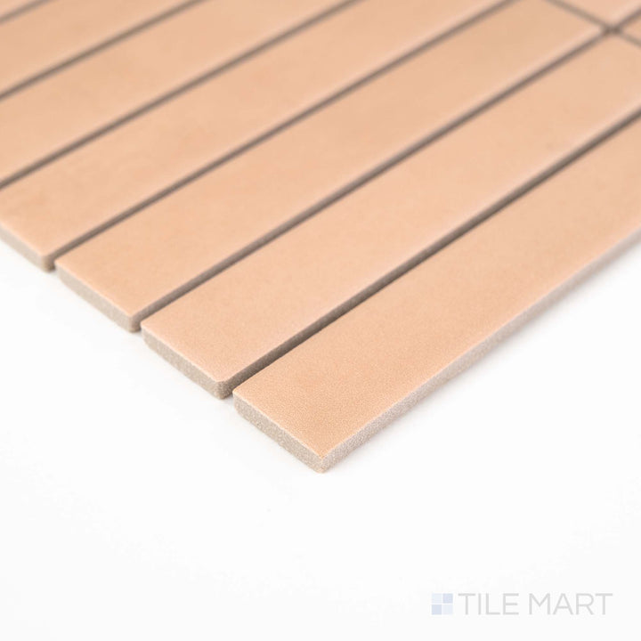 Corner view of Passaggi Blush 1x6 Grid Matte Porcelain Mosaic featuring soft pink tones in a sleek, linear grid layout – perfect for romantic and playful interiors.