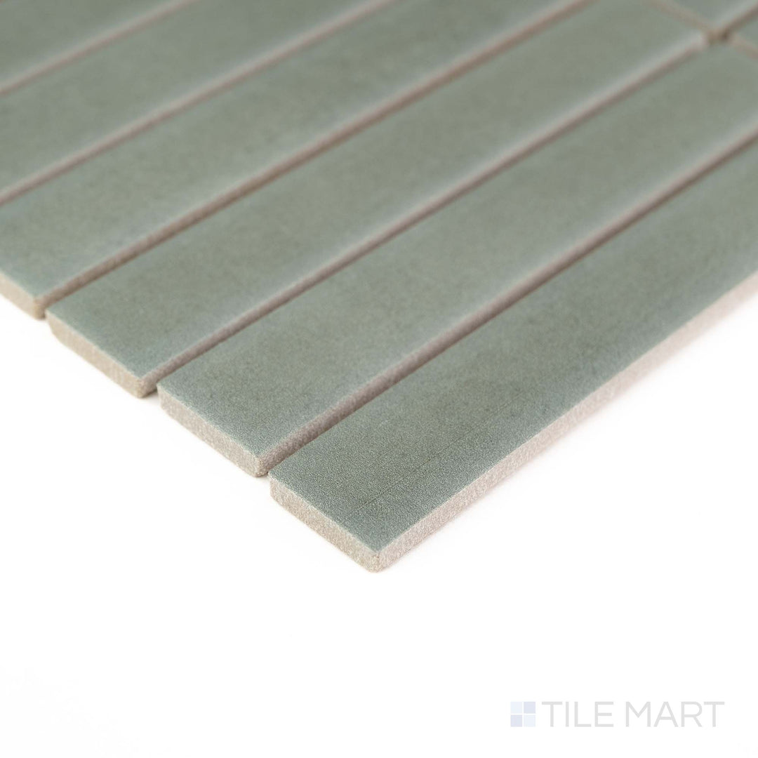 Corner detail of Passaggi Green 1x6 Grid Matte Porcelain Mosaic showcasing calming green hues in a modern stacked layout – great for nature-inspired design schemes.