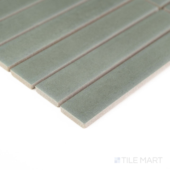 Corner detail of Passaggi Green 1x6 Grid Matte Porcelain Mosaic showcasing calming green hues in a modern stacked layout – great for nature-inspired design schemes.