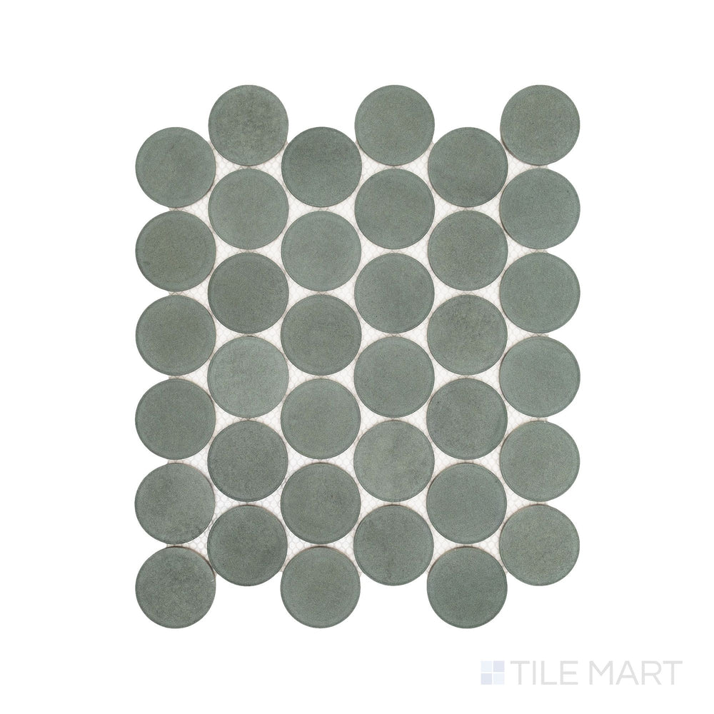 Flatlay display of Passaggi Green 2" Round Matte Porcelain Mosaic, showcasing soft green circular tiles ideal for serene, nature-inspired interiors.