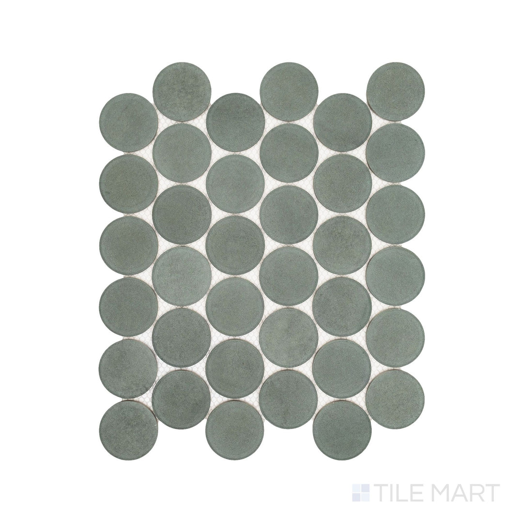 Flatlay display of Passaggi Green 2" Round Matte Porcelain Mosaic, showcasing soft green circular tiles ideal for serene, nature-inspired interiors.