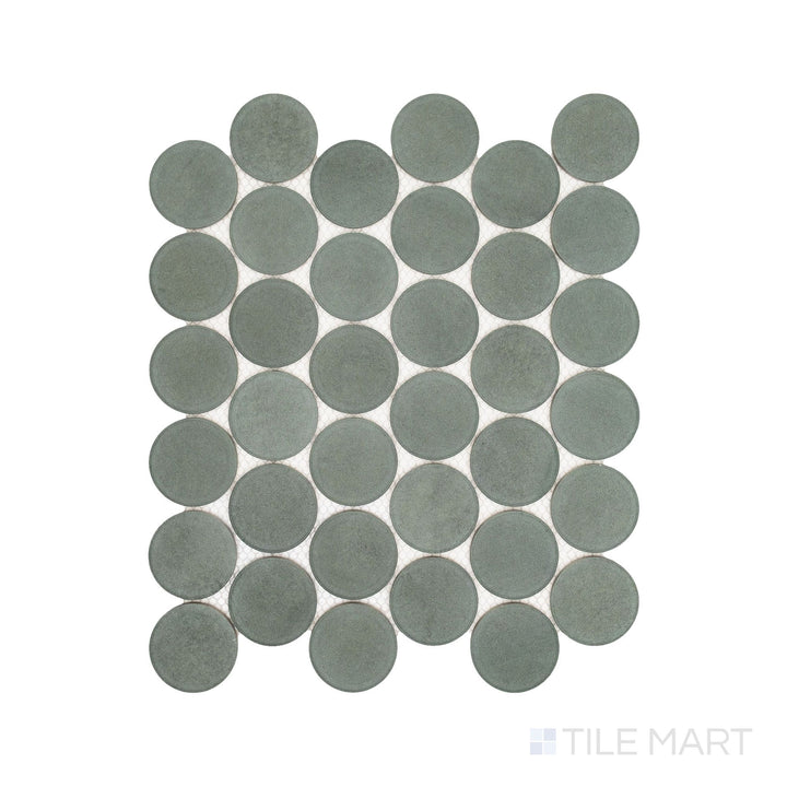 Flatlay display of Passaggi Green 2" Round Matte Porcelain Mosaic, showcasing soft green circular tiles ideal for serene, nature-inspired interiors.