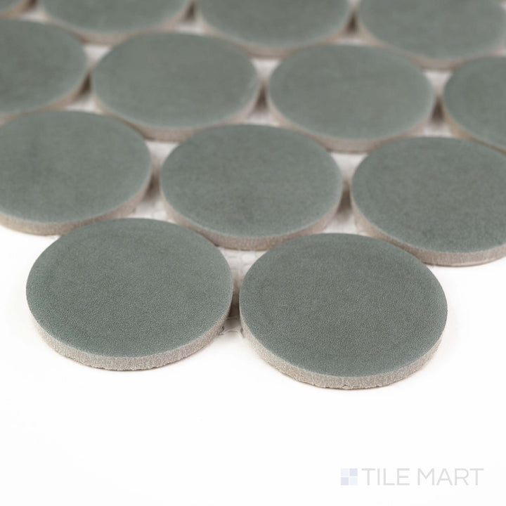 Corner angle of Passaggi Green 2" Round Matte Porcelain Mosaic featuring fresh green tones in a classic penny round format – perfect for spa-style or eclectic settings.