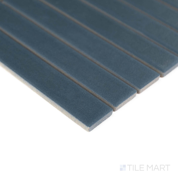 Corner view of Passaggi Blue 1x6 Grid Matte Porcelain Mosaic with cool blue shades and contemporary linear layout – ideal for serene backsplashes and decorative niches.
