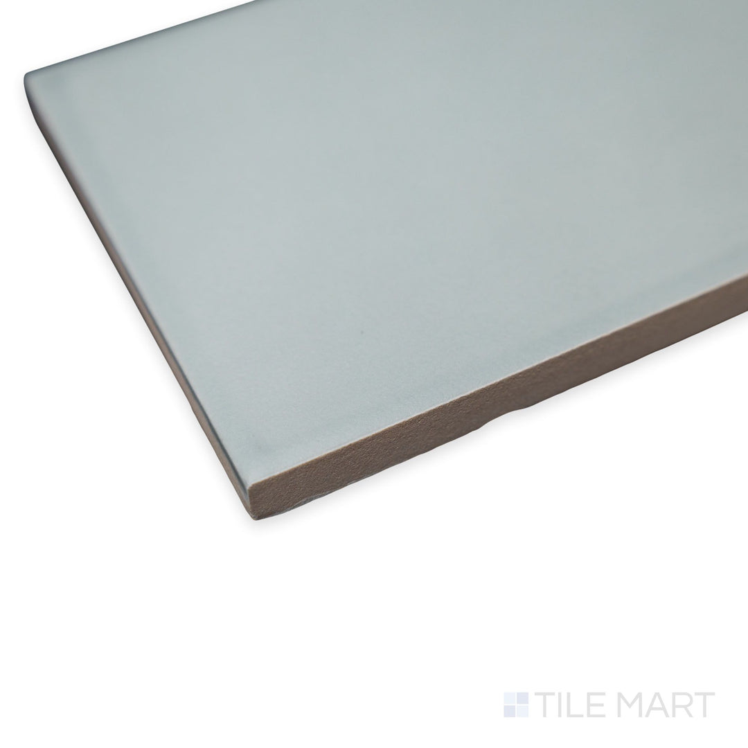 Angled look at Van Base Plain Oliva tile with its muted olive hue and clean-edged matte ceramic profile.