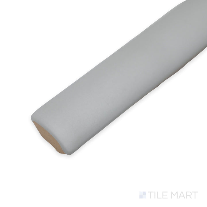 Corner view of Van Verde Jolly tile revealing its long narrow shape and smooth dark green ceramic surface.