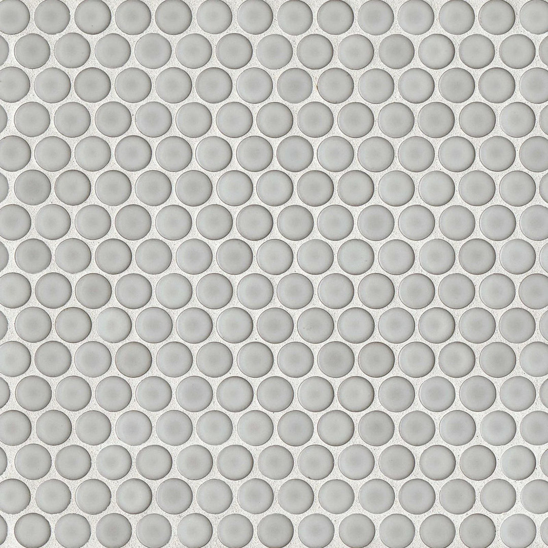 An overhead shot of the 360° Dove Grey penny round tile highlights its smooth, polished surface and soft grey shade, bringing a refined, modern touch to interiors.
